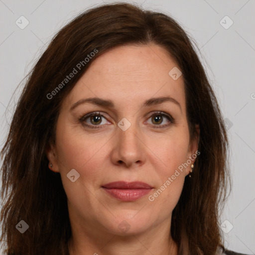 Joyful white adult female with long  brown hair and brown eyes