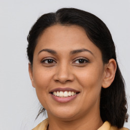 Joyful latino young-adult female with medium  brown hair and brown eyes