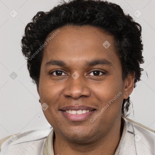 Joyful black young-adult male with short  brown hair and brown eyes