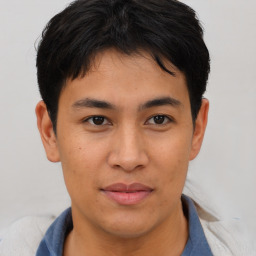 Joyful asian young-adult male with short  brown hair and brown eyes