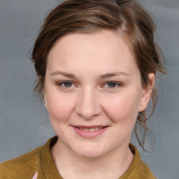 Joyful white young-adult female with medium  brown hair and blue eyes