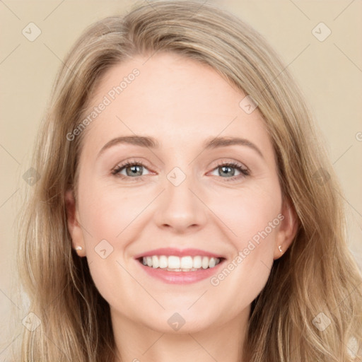 Joyful white young-adult female with long  brown hair and blue eyes