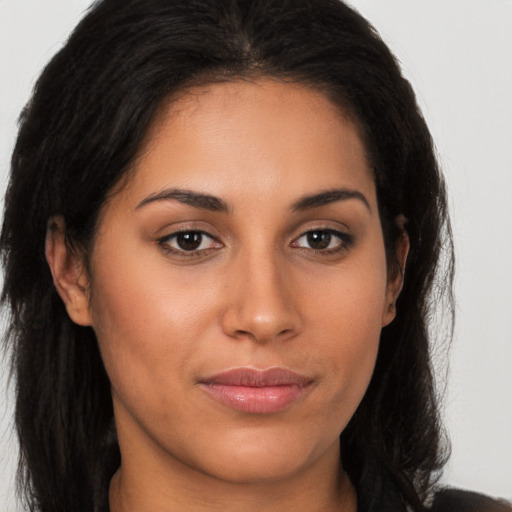 Joyful latino young-adult female with long  brown hair and brown eyes