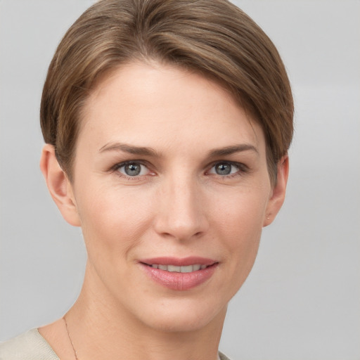 Joyful white young-adult female with short  brown hair and grey eyes