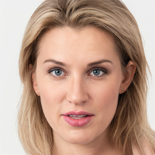 Joyful white young-adult female with long  brown hair and blue eyes