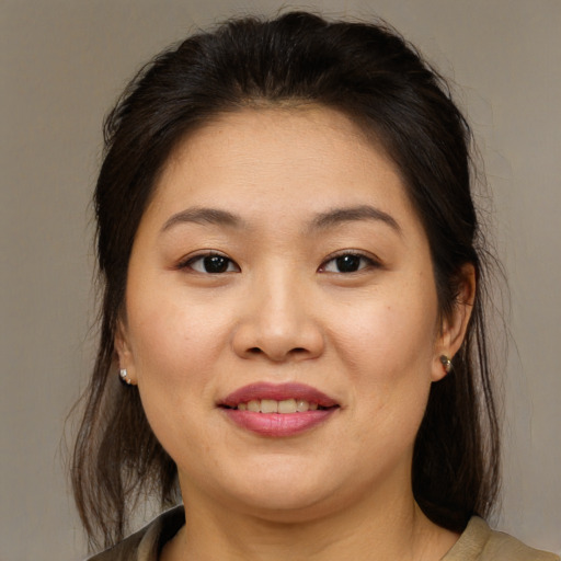 Joyful asian young-adult female with medium  brown hair and brown eyes