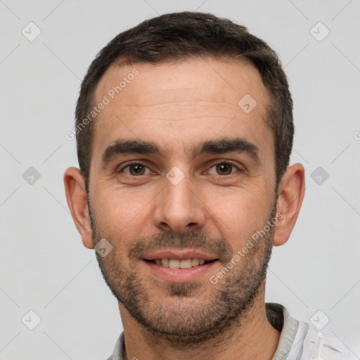 Joyful white young-adult male with short  brown hair and brown eyes