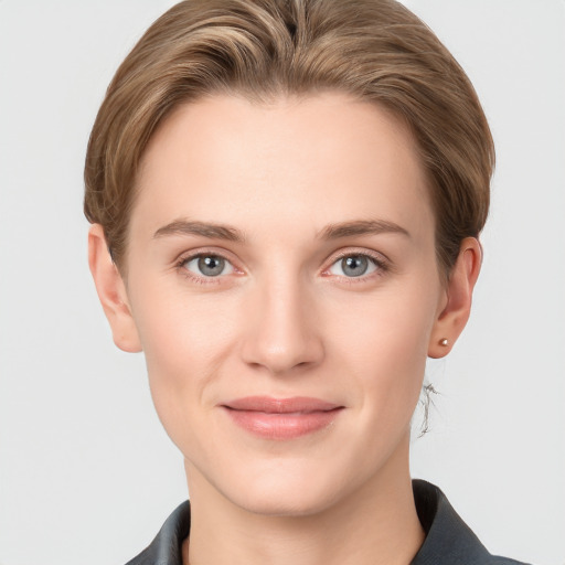 Joyful white young-adult female with short  brown hair and grey eyes