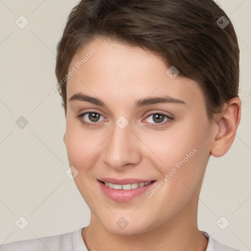 Joyful white young-adult female with short  brown hair and brown eyes