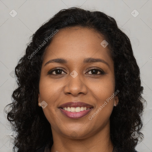 Joyful black young-adult female with long  brown hair and brown eyes