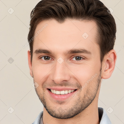 Joyful white young-adult male with short  brown hair and brown eyes