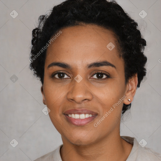 Joyful black young-adult female with short  black hair and brown eyes