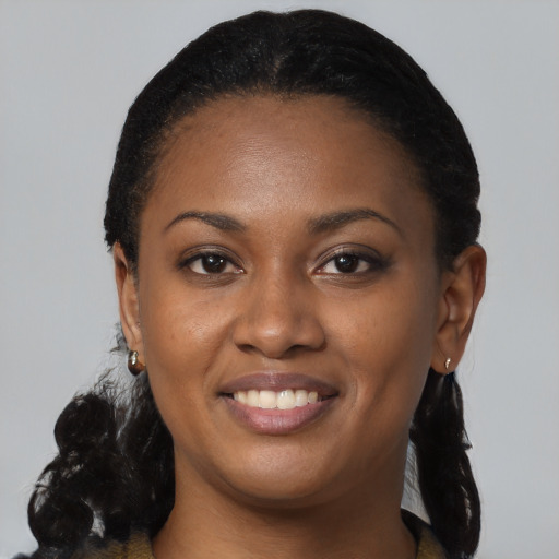 Joyful black young-adult female with medium  black hair and brown eyes