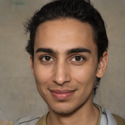 Joyful latino young-adult male with short  brown hair and brown eyes