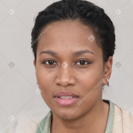 Joyful black young-adult female with short  black hair and brown eyes