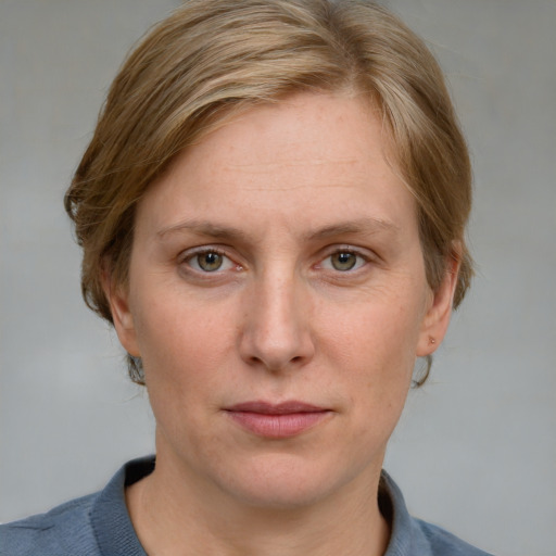 Joyful white adult female with medium  brown hair and blue eyes