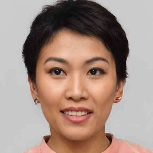 Joyful asian young-adult female with short  black hair and brown eyes