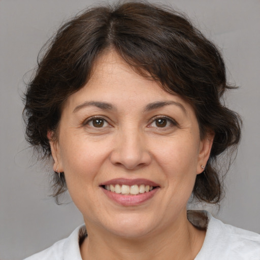 Joyful white adult female with medium  brown hair and brown eyes