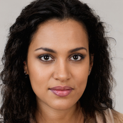 Joyful latino young-adult female with long  brown hair and brown eyes
