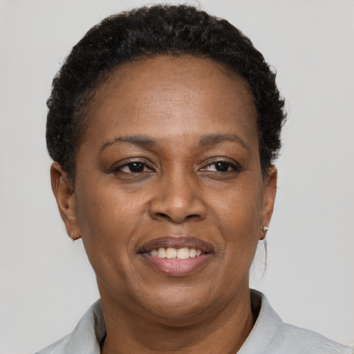 Joyful latino adult female with short  brown hair and brown eyes