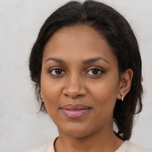Joyful black young-adult female with medium  brown hair and brown eyes