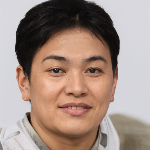 Joyful asian adult female with short  brown hair and brown eyes