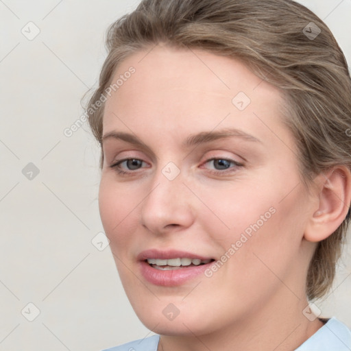 Joyful white young-adult female with medium  brown hair and blue eyes