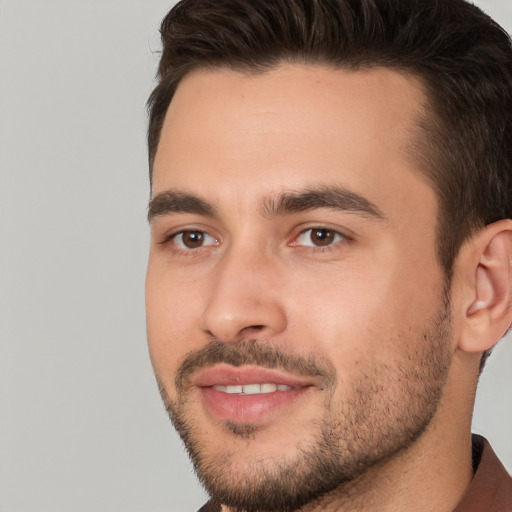 Joyful white young-adult male with short  brown hair and brown eyes