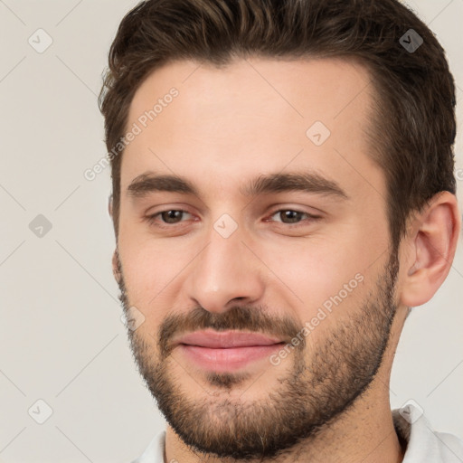 Joyful white young-adult male with short  brown hair and brown eyes