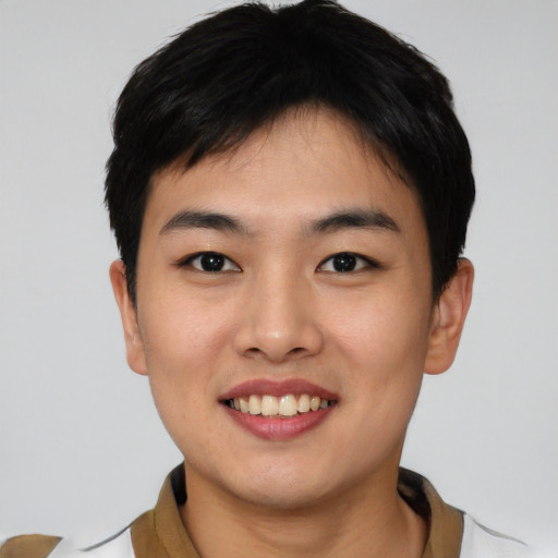 Joyful asian young-adult male with short  black hair and brown eyes