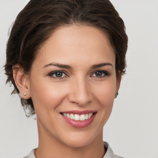 Joyful white young-adult female with medium  brown hair and brown eyes