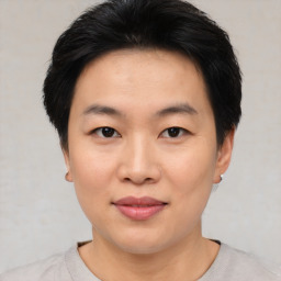 Joyful asian young-adult female with short  black hair and brown eyes