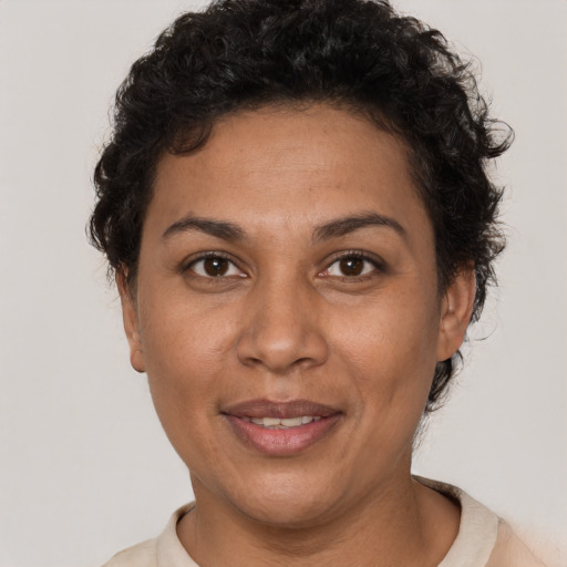 Joyful latino adult female with short  brown hair and brown eyes