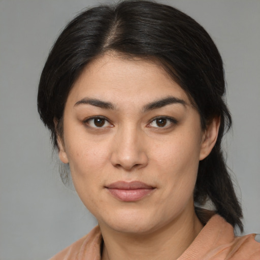 Joyful latino young-adult female with medium  brown hair and brown eyes