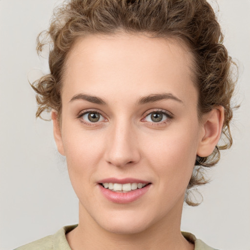 Joyful white young-adult female with medium  brown hair and green eyes