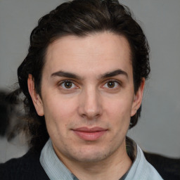 Joyful white young-adult male with medium  brown hair and brown eyes