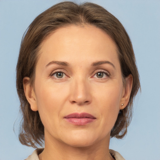 Joyful white adult female with medium  brown hair and grey eyes