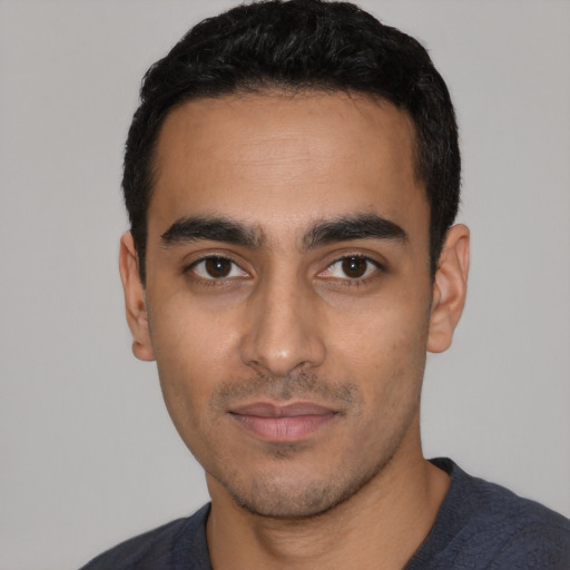 Neutral latino young-adult male with short  black hair and brown eyes