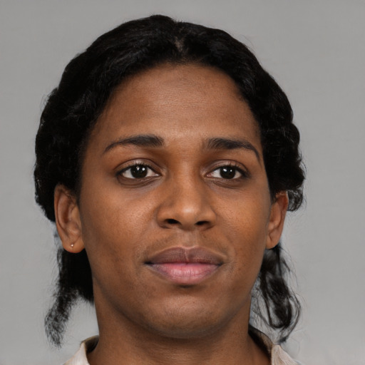 Joyful black young-adult female with short  black hair and brown eyes