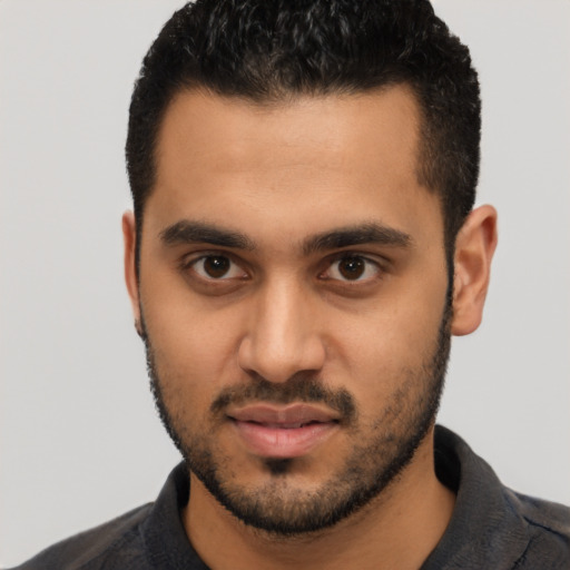 Joyful latino young-adult male with short  black hair and brown eyes