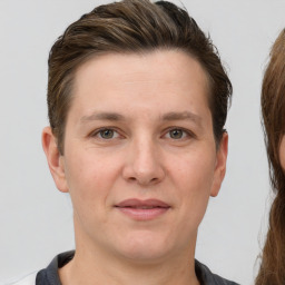 Joyful white adult female with short  brown hair and grey eyes