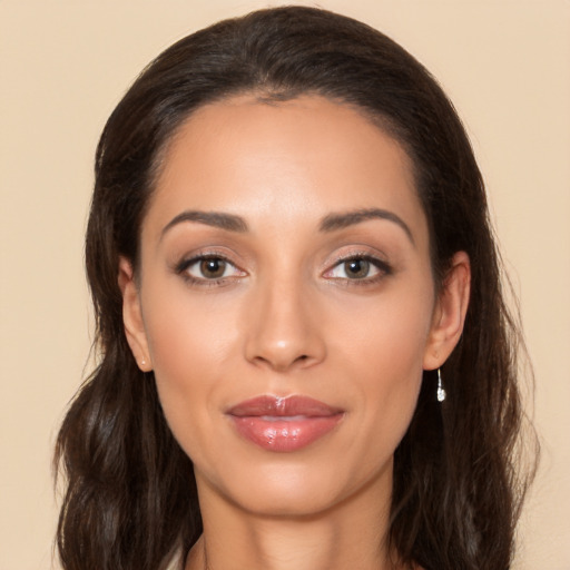 Joyful white young-adult female with long  brown hair and brown eyes