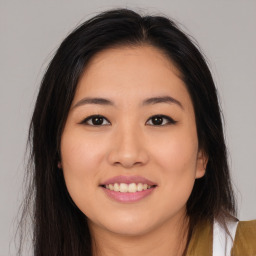 Joyful asian young-adult female with long  brown hair and brown eyes