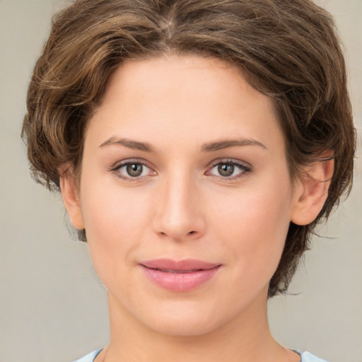 Joyful white young-adult female with medium  brown hair and green eyes