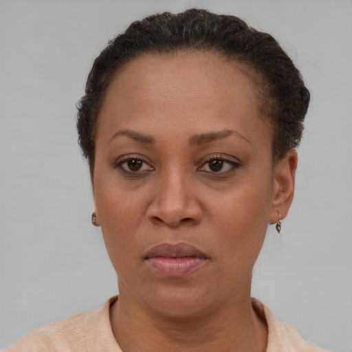 Joyful latino adult female with short  brown hair and brown eyes