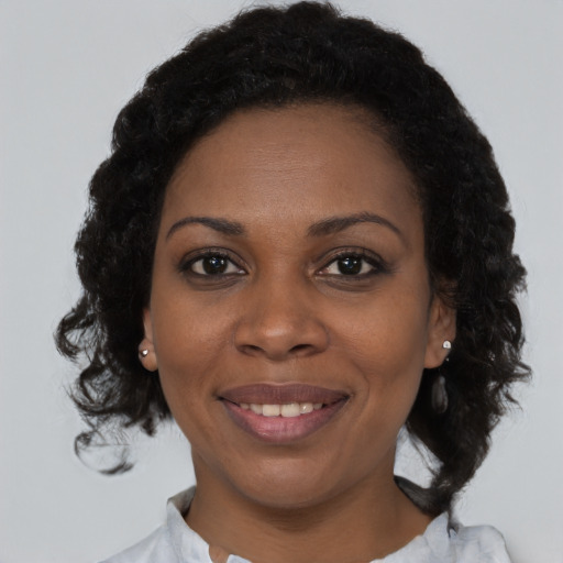 Joyful black young-adult female with medium  brown hair and brown eyes