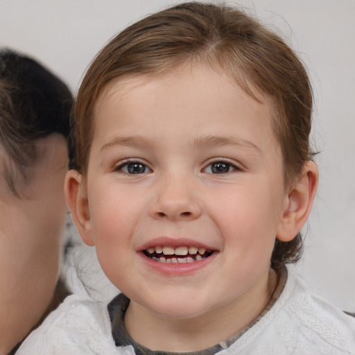 Joyful white child female with medium  brown hair and brown eyes