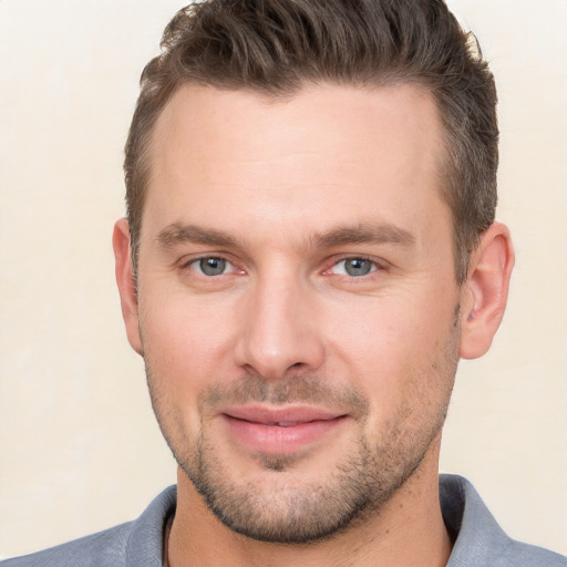 Joyful white young-adult male with short  brown hair and brown eyes