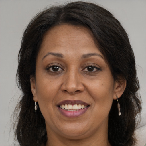 Joyful white adult female with long  brown hair and brown eyes