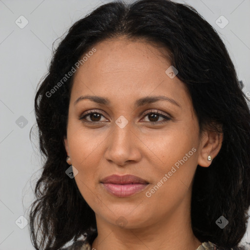 Joyful latino adult female with long  brown hair and brown eyes